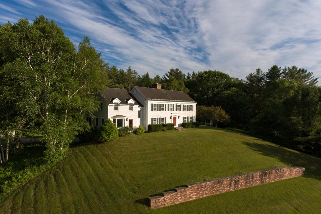 an aerial view of a white house with a large yard at The Garden Estate in West Rutland