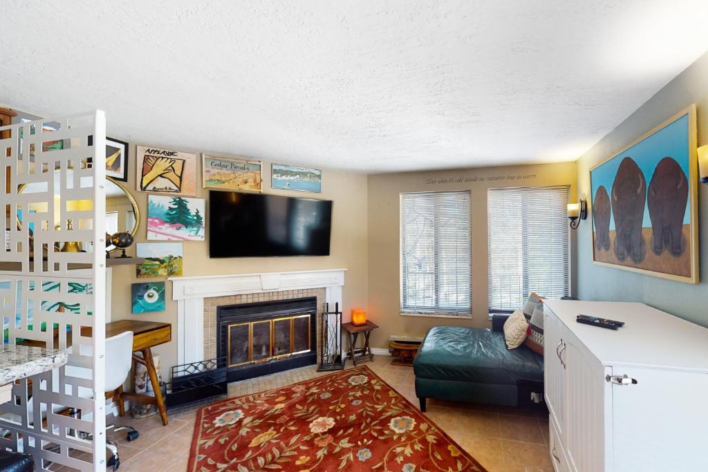 a living room with a fireplace and a tv at Timberbrook #110B in Brian Head