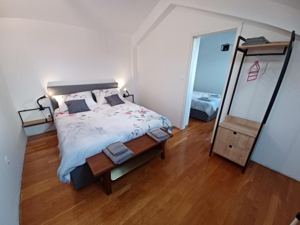 a bedroom with a large bed and a mirror at Stunning new apartment in centre of Buzet in Buzet