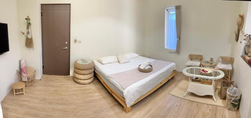a bedroom with a bed and a table and a window at W24墾丁民宿墾丁大街一館bnb in Kenting