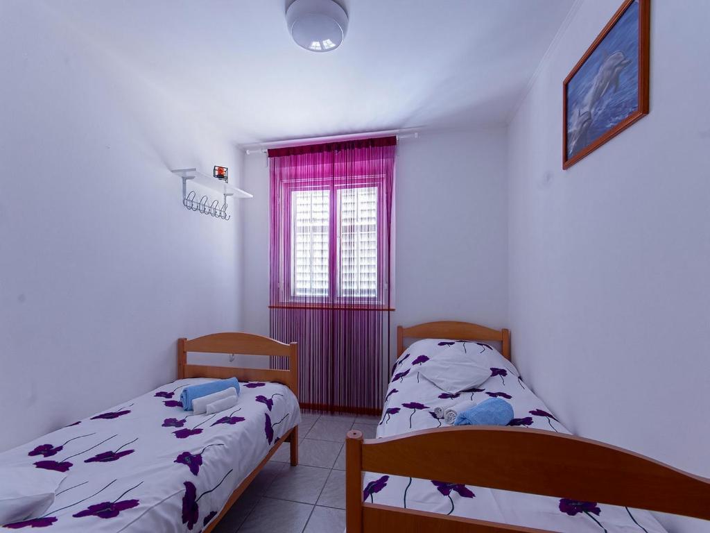 Posteľ alebo postele v izbe v ubytovaní Holiday Home Dalmatia Sokolić