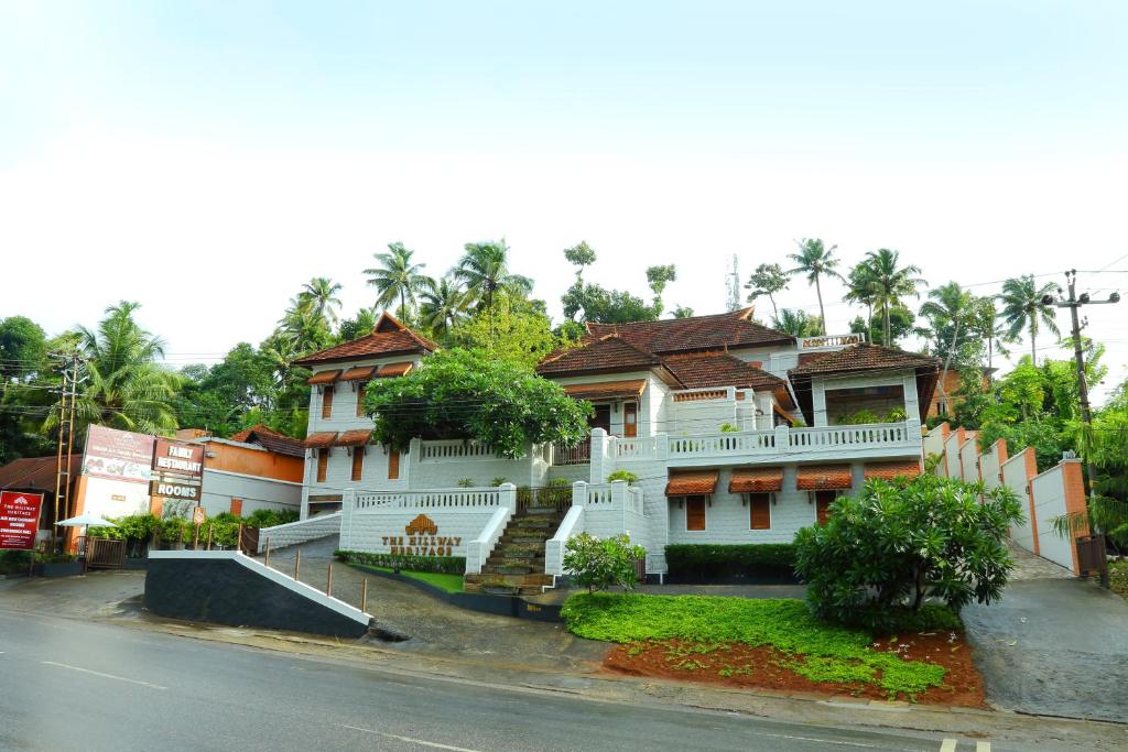 a large white house on the side of a street at THE HILLWAY HERITAGE in Trivandrum