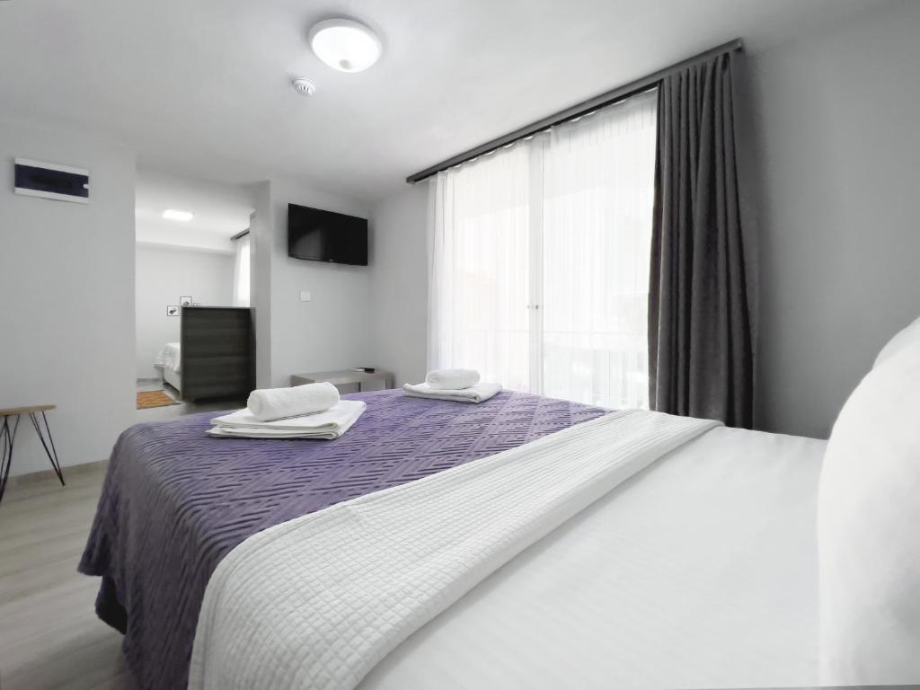 A bed or beds in a room at Azize Palas Apart Otel