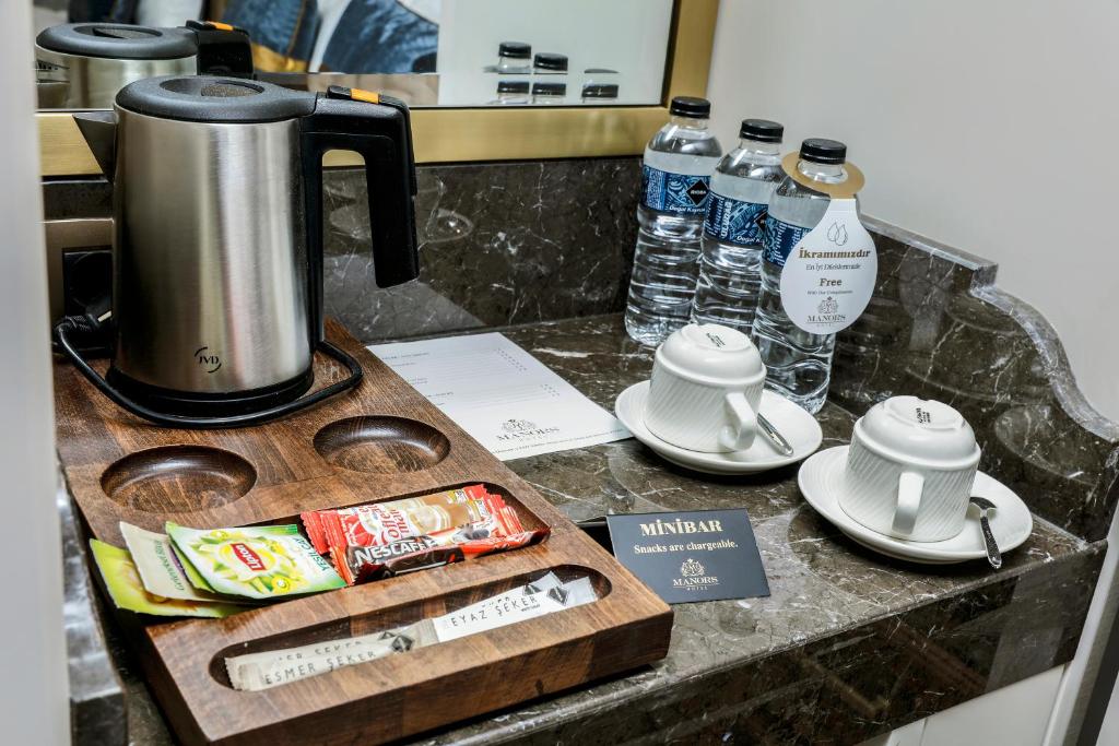 Coffee and tea making facilities at MANORS HOTEL