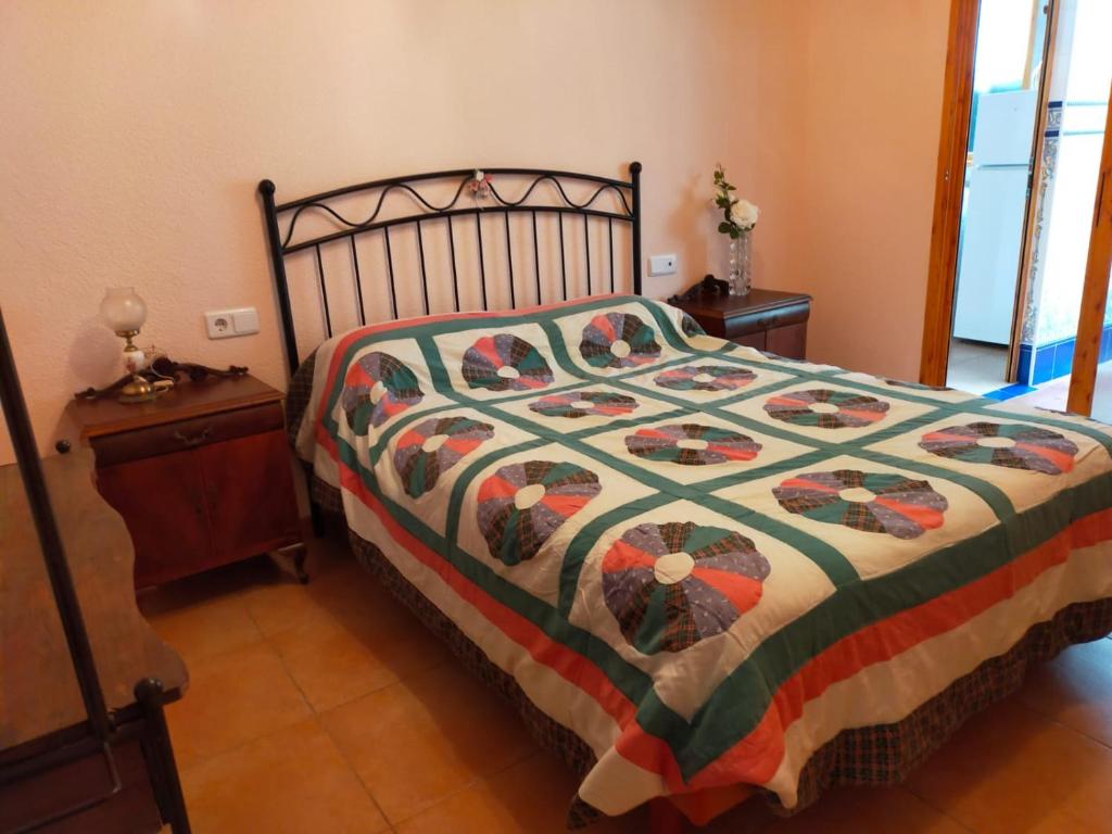 a bedroom with a bed with a colorful quilt at Apartamentos Casa May II - Centro Benidorm in Benidorm