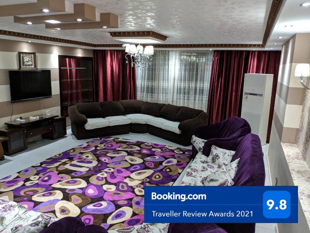 a living room with a couch and a large carpet at Maadi Apartment - 3 rooms ( Families Only ) in Cairo