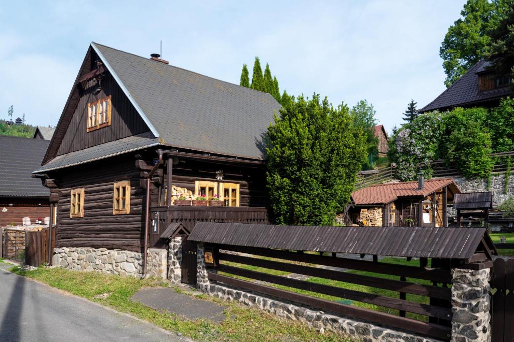 a large wooden house with a black roof at Traditional cozy cottage BOCANKA in Nižná Boca