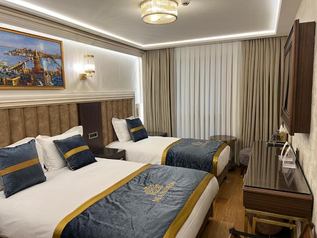 A bed or beds in a room at MANORS HOTEL