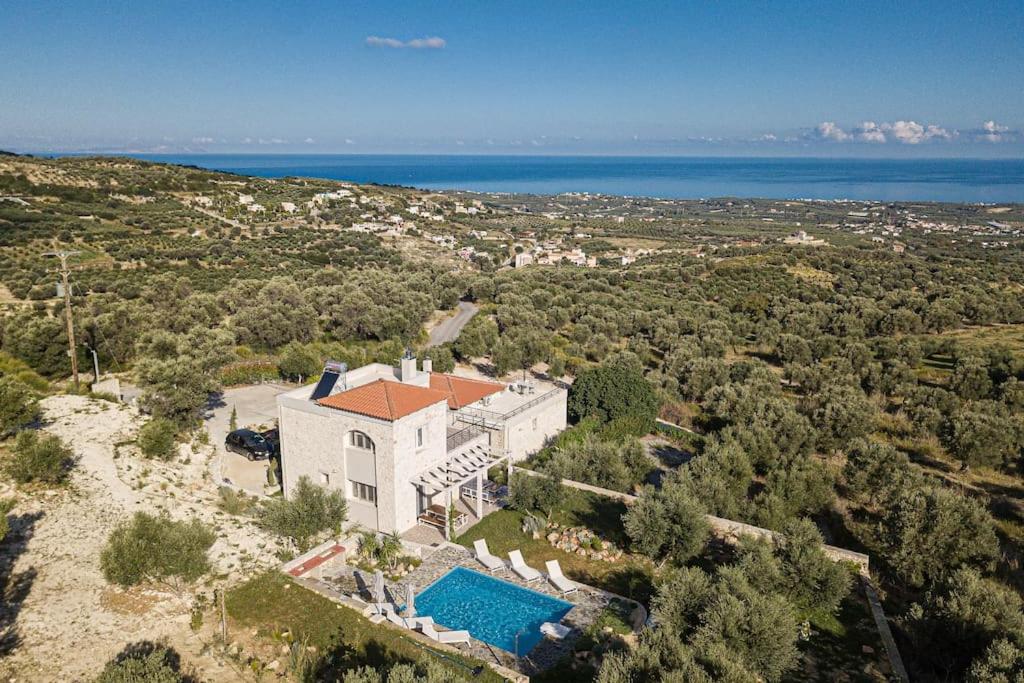 una vista aérea de una casa con piscina en Komfortvilla sensationeller Meerblick priv. Pool en Agia Triada