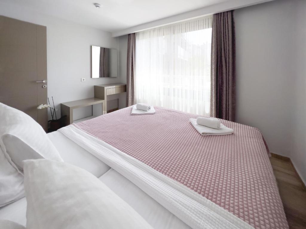 A bed or beds in a room at Azize Palas Apart Otel