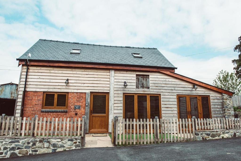 a small house with a wooden fence in front of it at Swallows Rest in Montgomery