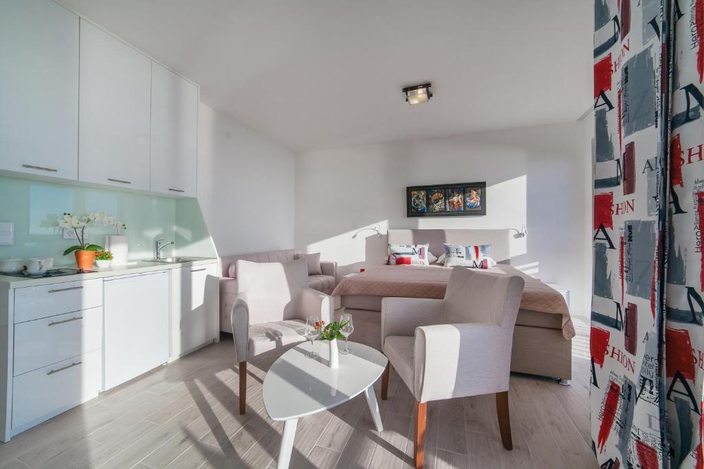 a kitchen and living room with a table and chairs at Villa Mona 2 in Budva