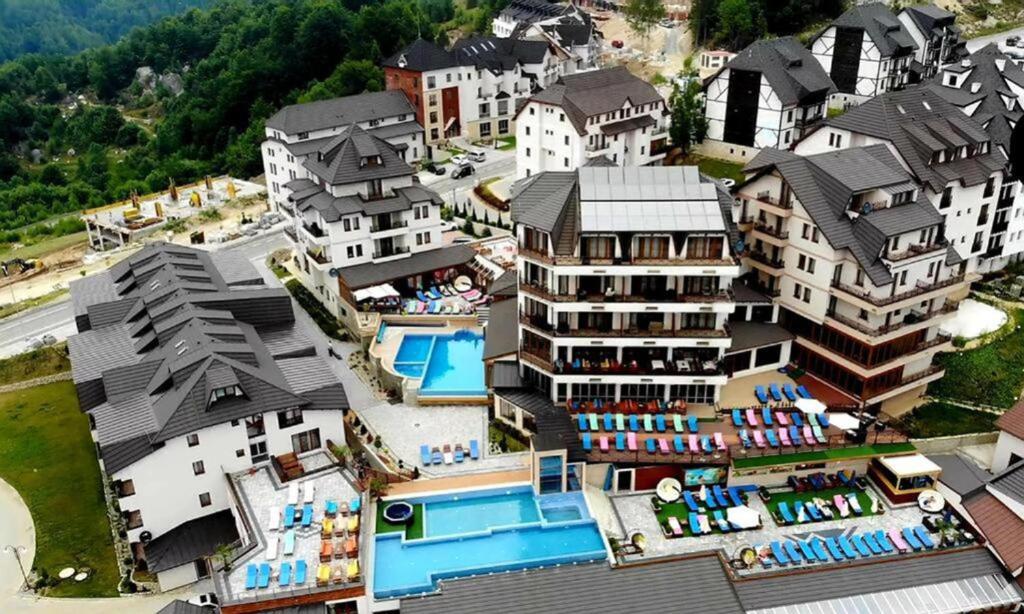 an aerial view of a resort with a pool and buildings at Milmari - Wellness & Spa in Kopaonik