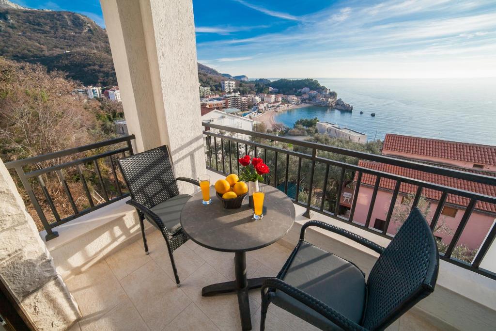 a balcony with a table and chairs and a view of the ocean at Villa Mona 2 in Budva