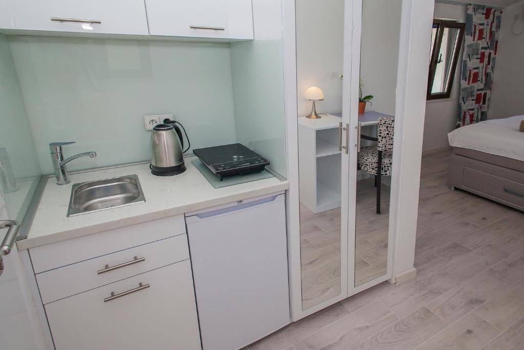 a kitchen with a sink and a counter top at Villa Mona 2 in Budva