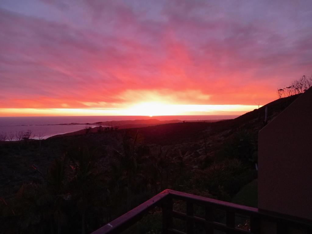 a sunset with the sun setting over the ocean at 110 Bay View in Brenton-on-Sea