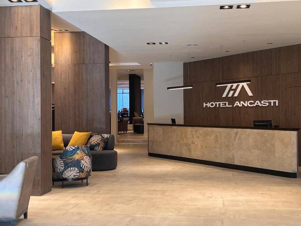 a hotel lobby with a hotel embassy sign on the wall at Nuevo Hotel Ancasti in San Fernando del Valle de Catamarca