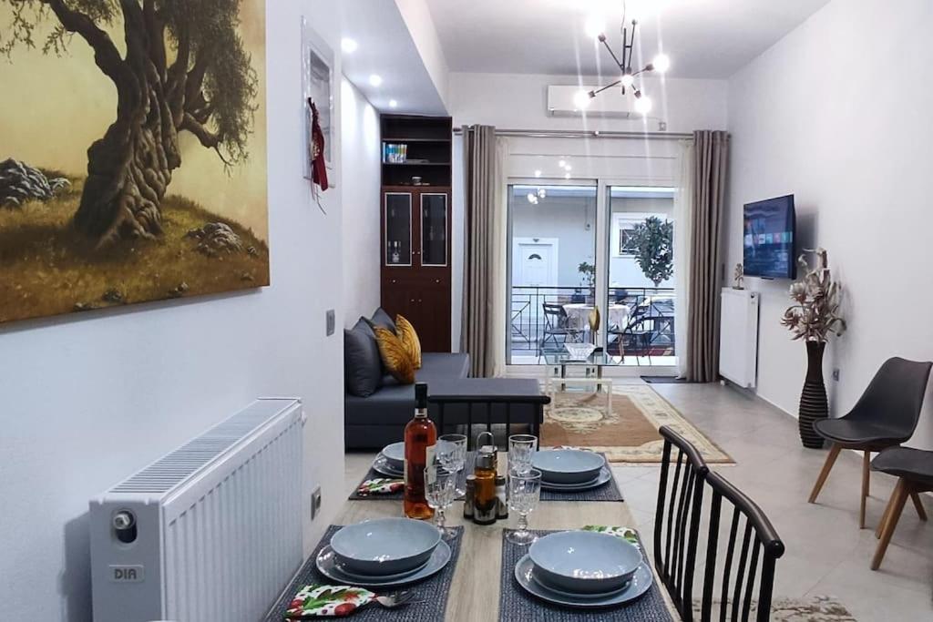 a dining room and living room with a table and chairs at Modern apartment in Itea in Itea