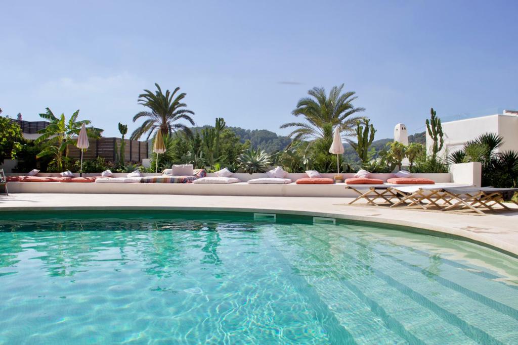 a swimming pool with chaise lounges and a resort at La Pandilla Ibiza in Sant Francesc de s'Estany