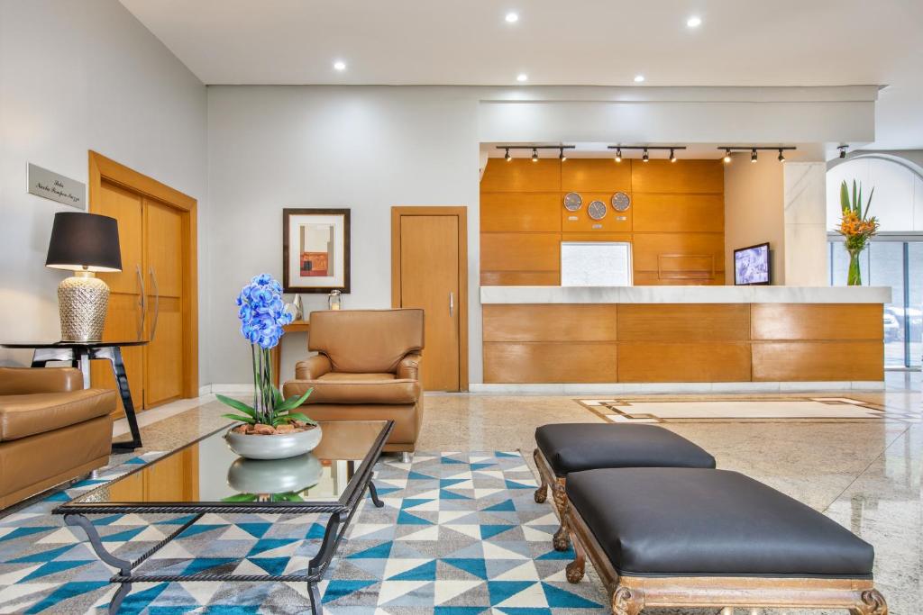 a living room with a couch and a table at Plaza Inn American Loft in Sao Paulo