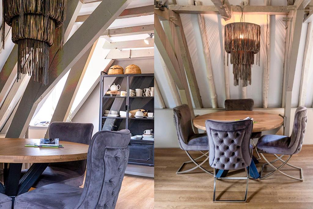 ein Esszimmer mit einem Holztisch und Stühlen in der Unterkunft Supreme City Penthouse in Leeuwarden