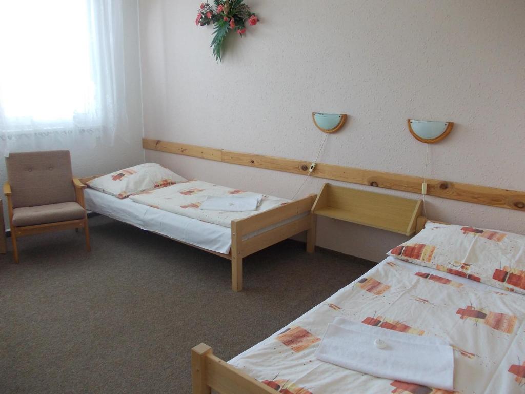 Postel nebo postele na pokoji v ubytování Hotel Milotel