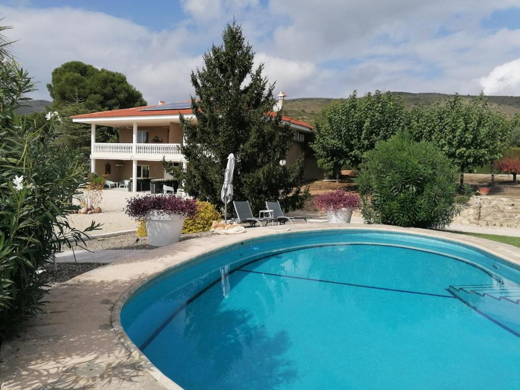 a large blue swimming pool in front of a house at Atidos Adults only in Ontinyent