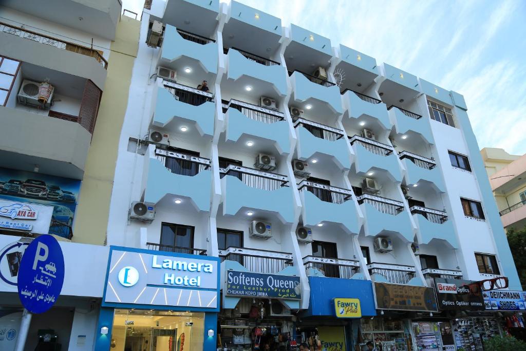 a building with people sitting on the balconies of it at Lamera Hotel in Hurghada