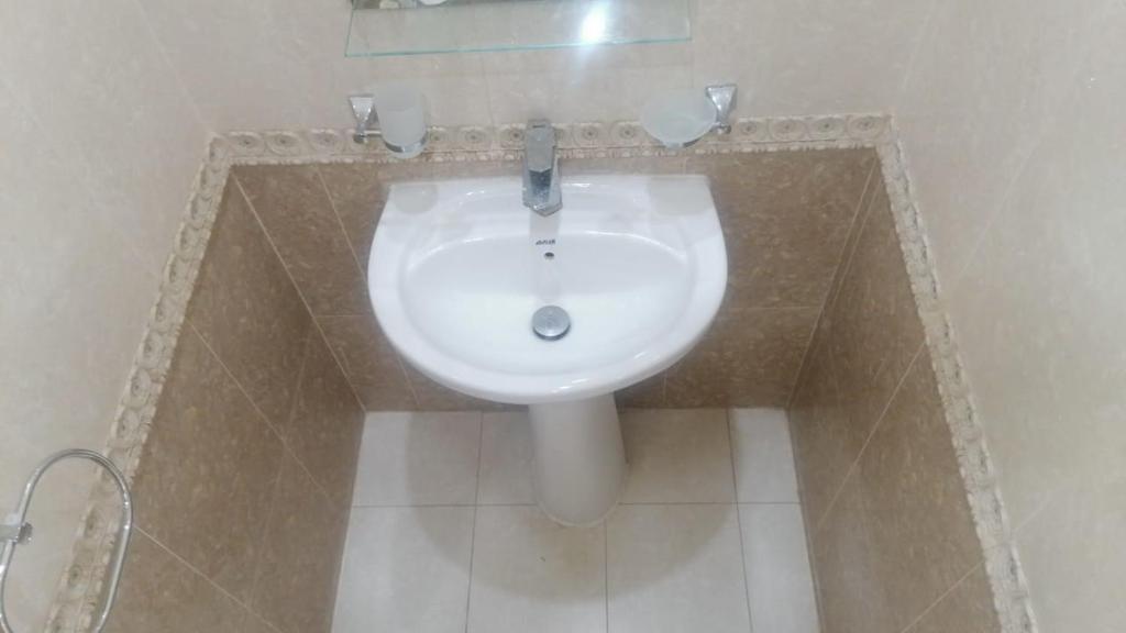 a bathroom with a white sink in a room at قصر اباهي للوحدات السكنية in Al Jubail