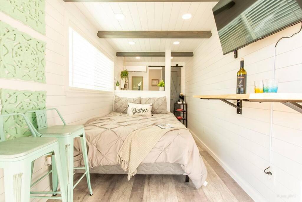 a small bedroom with a bed and a table at The Container Retreat @ 290 Wine Trail #10 Welcome friends! in Hye