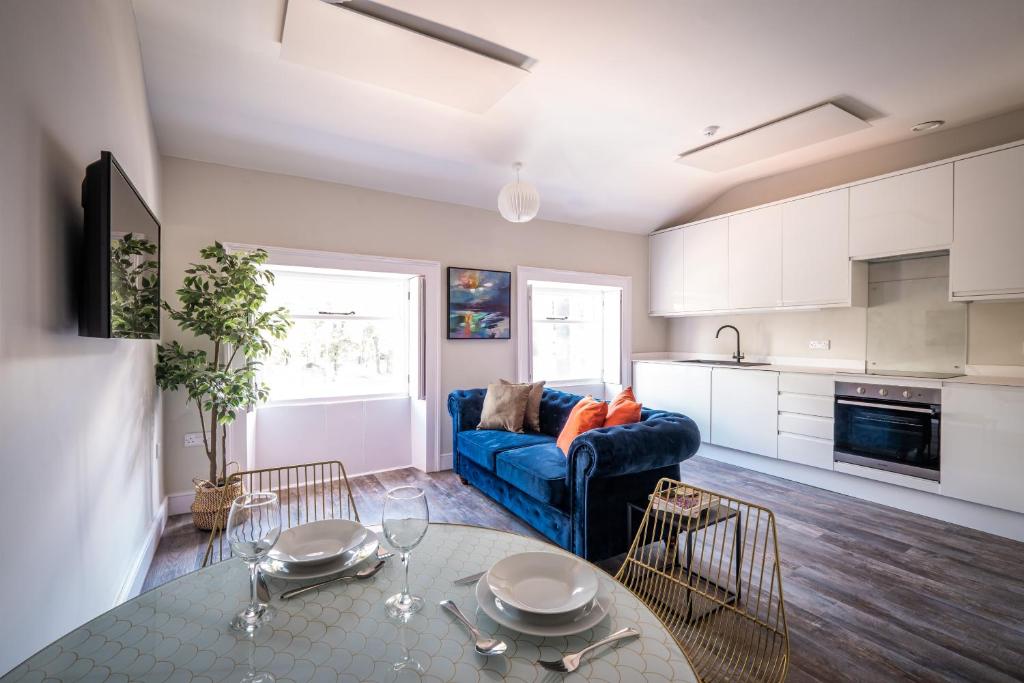 a living room with a blue couch and a table at Dalton Sq Apartment 2 in Lancaster