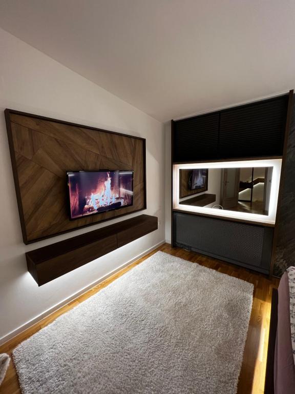 a living room with a flat screen tv on a wall at Inverno Apartments Bjelašnica in Bjelašnica
