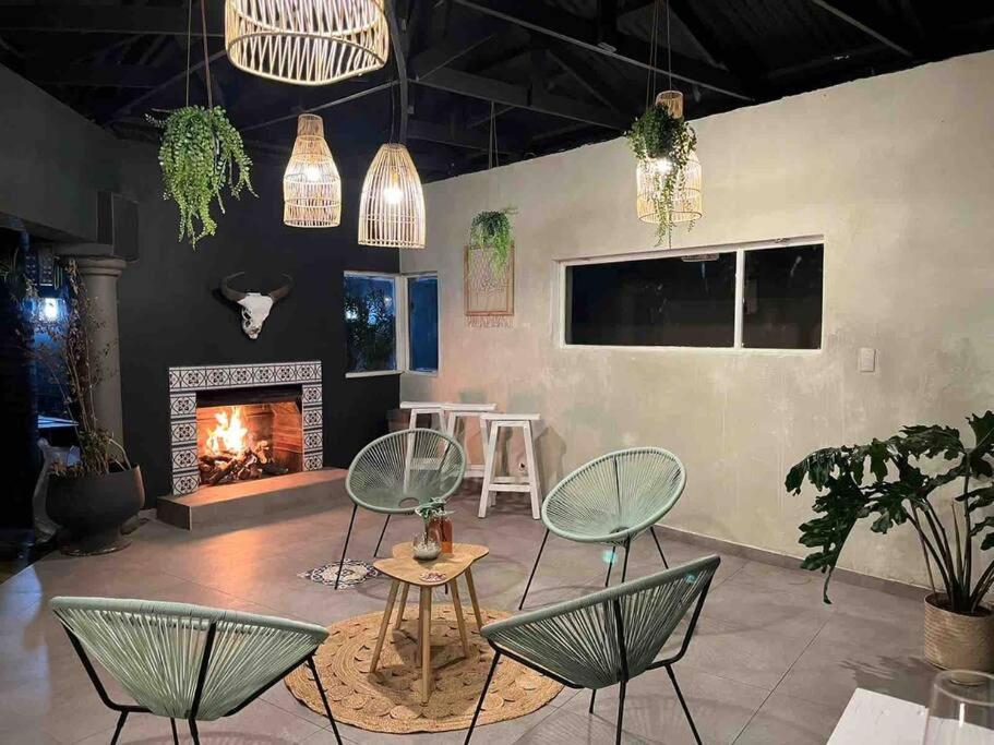 a living room with chairs and a fireplace at The Minimalist Hide away in Benoni
