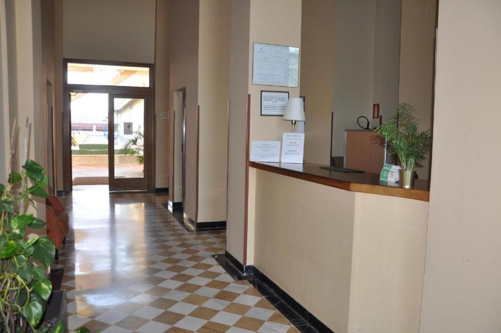 a lobby with a reception desk and a checkered floor at Apartamento FIBES edificio LUX SEVILLA in Seville