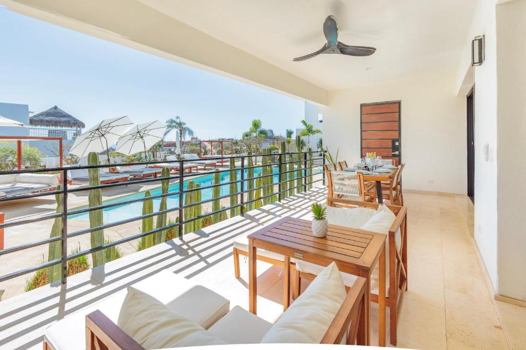 a room with a balcony with a view of the water at Cerritos Surf Residences in El Pescadero