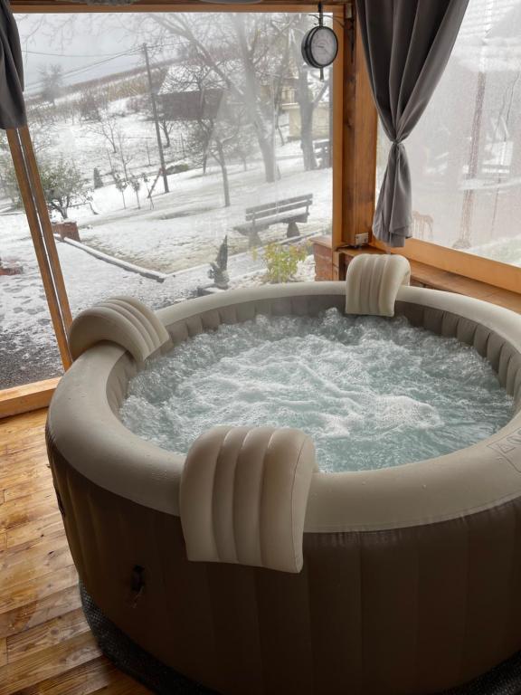 a hot tub in a room with a window at Holiday home DEDINA HIŽICA in Sveti Urban