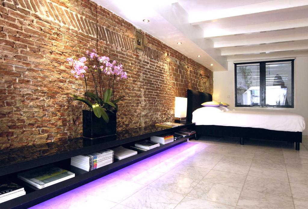 Giường trong phòng chung tại Amsterdam Boutique Apartments