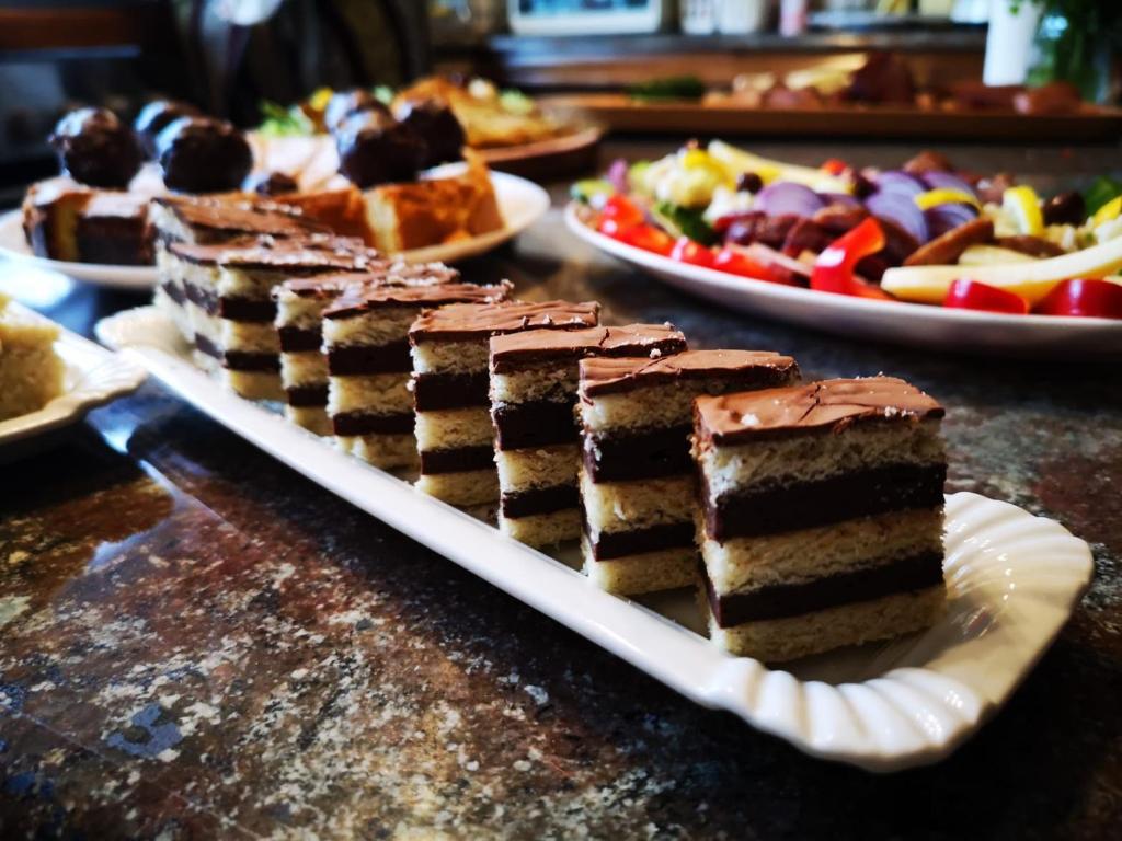 a piece of cake on a plate on a table at Pensiunea Bradet in Broşteni