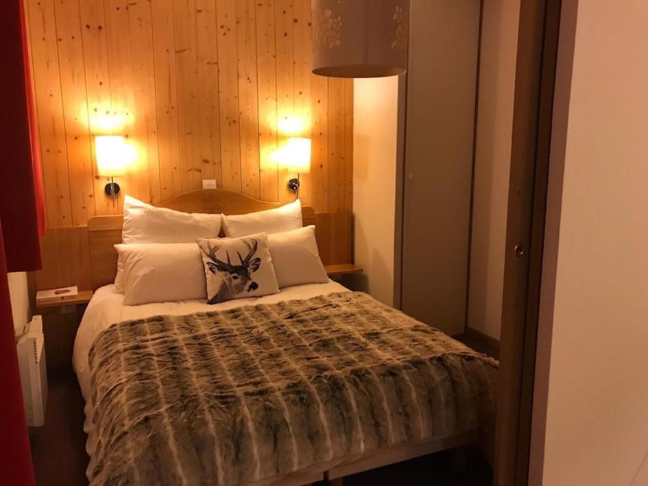 1 dormitorio con 1 cama grande y 2 almohadas en Cosy Montagne, en Valmeinier