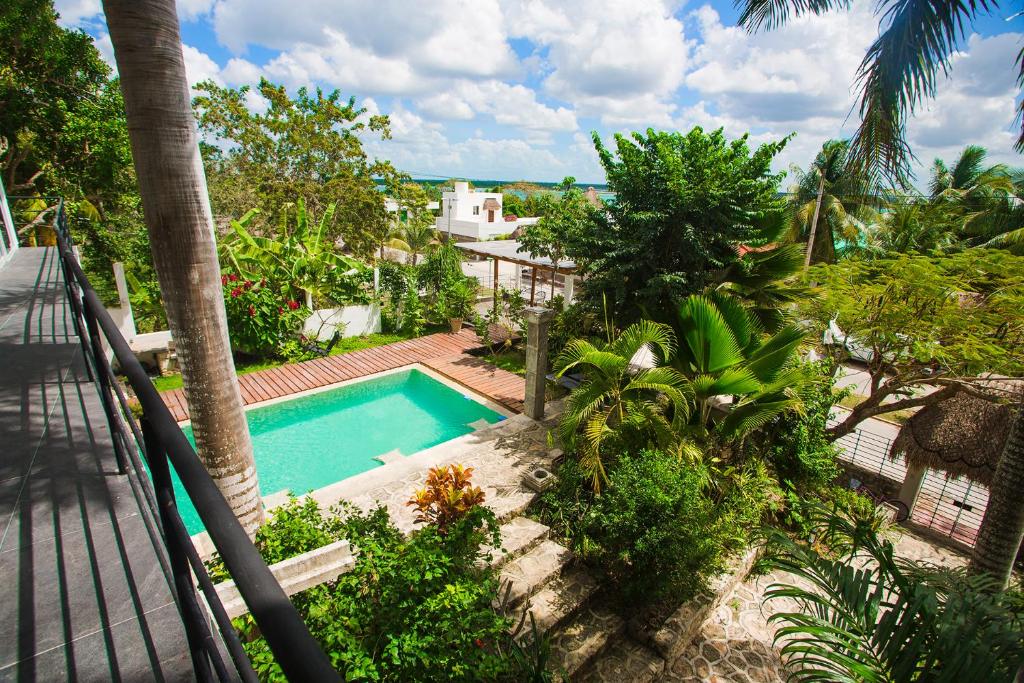 a view of a swimming pool from a balcony at Camino del Alma Apartments in Bacalar