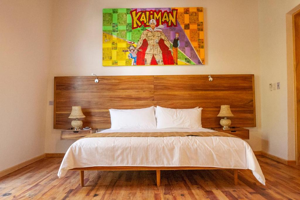 a bedroom with a large bed with a wooden headboard at NaNa Vida CDMX in Mexico City