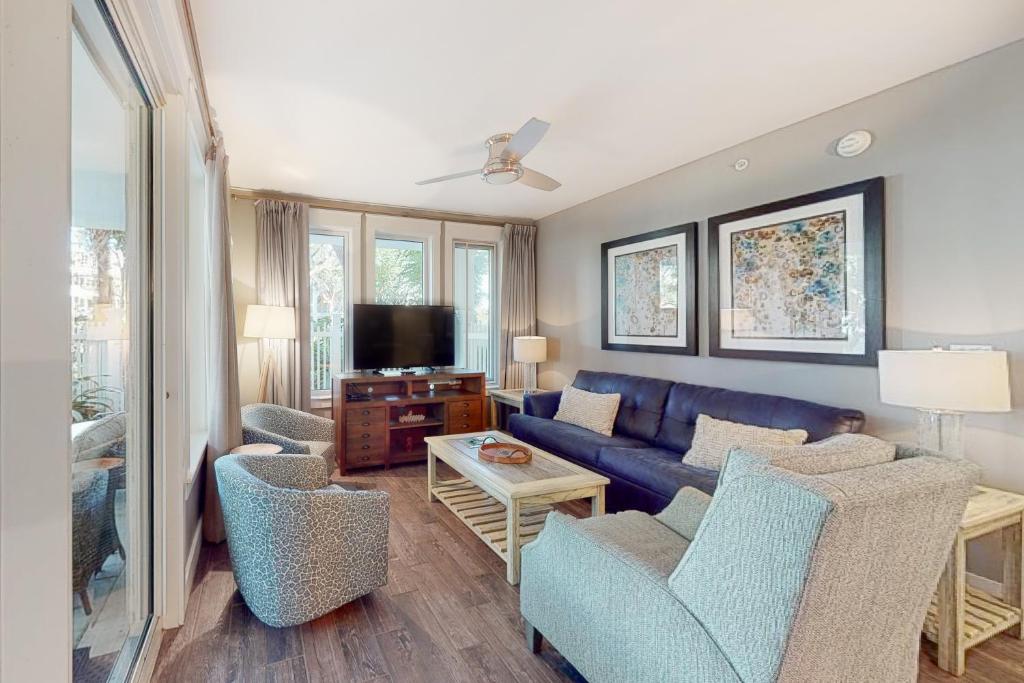 a living room with a blue couch and chairs at Baytowne Wharf - Observation Point North #351 in Destin