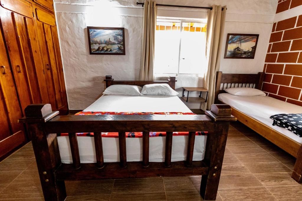 Ένα ή περισσότερα κρεβάτια σε δωμάτιο στο Finca-Hotel Montecarlo Guatape by Hope