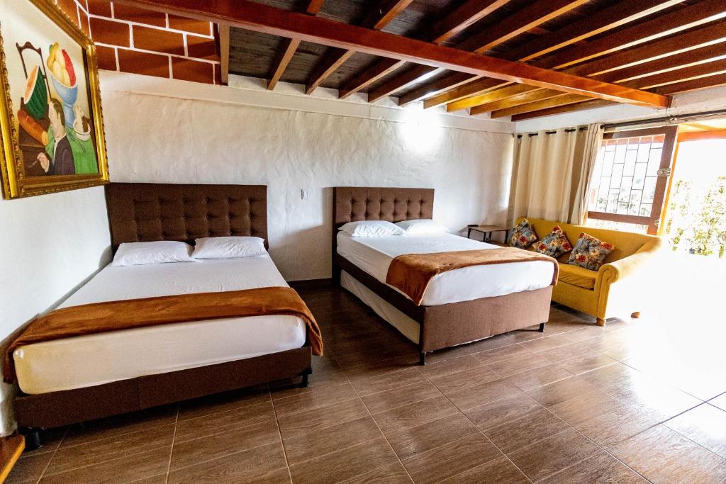 Ένα ή περισσότερα κρεβάτια σε δωμάτιο στο Finca-Hotel Montecarlo Guatape by Hope