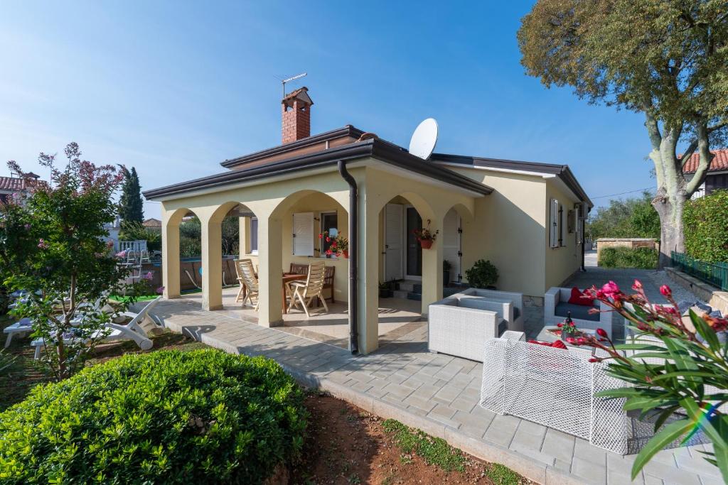 a gazebo with a table and chairs on a patio at Villa Luck in Veleniki