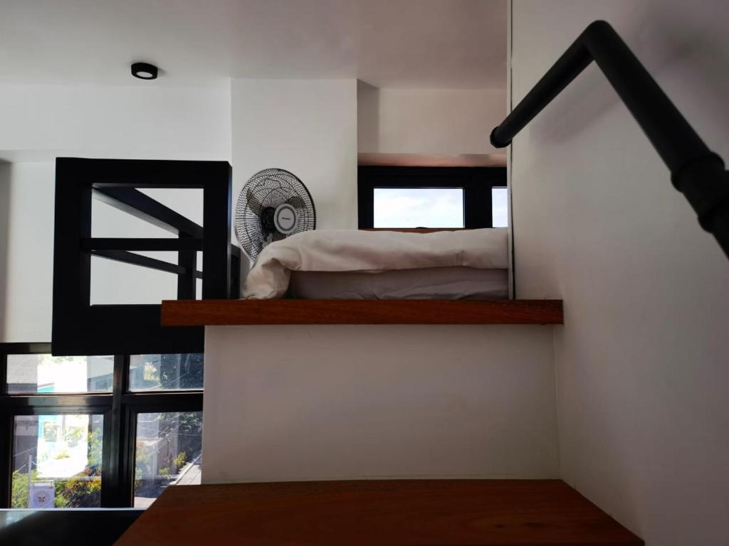 a bedroom with a bed on a stair case at Burj Calapan in Calapan