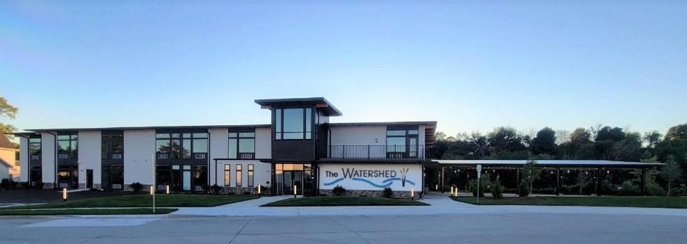 a large building with a sign in front of it at Watershed Hotel in Sheboygan