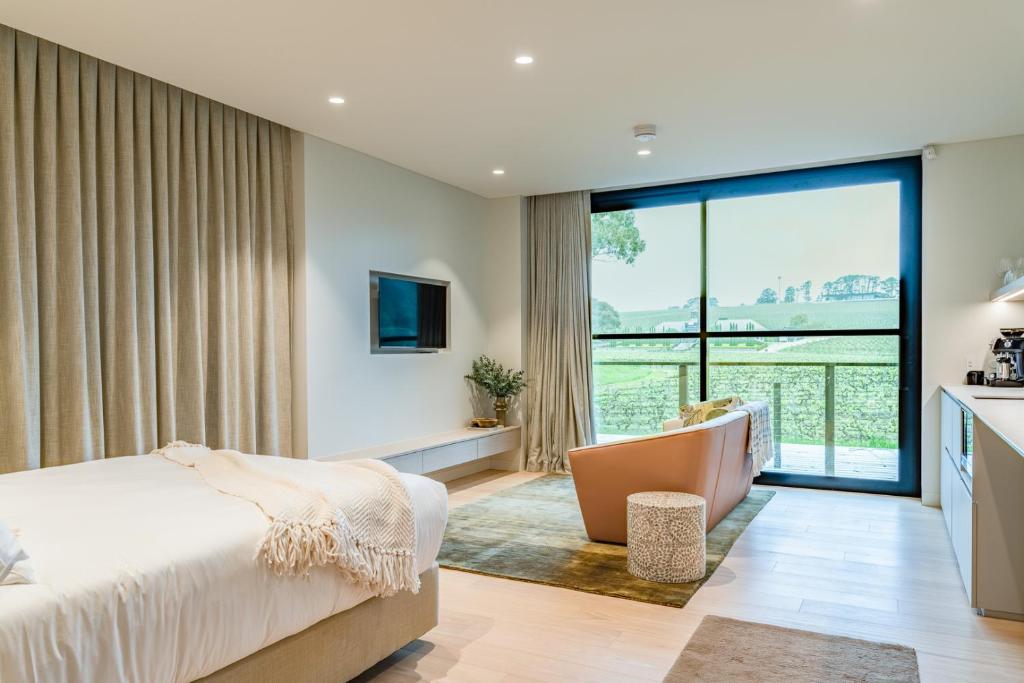 a bedroom with a bed and a large window at Beresford Estate in McLaren Flat