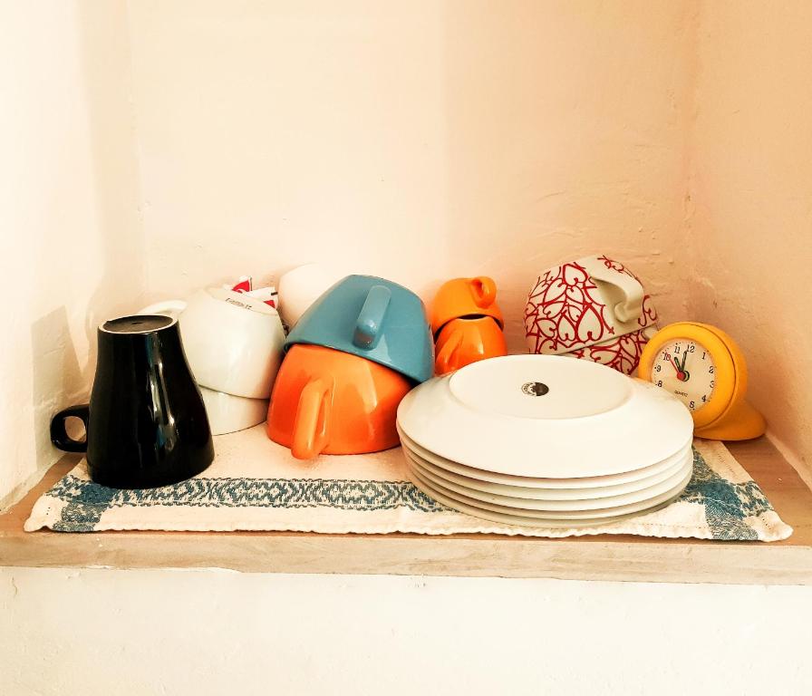 un estante con platos y otros artículos de cocina. en La Casetta di Alice en Villalago