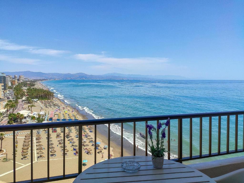 a balcony with a view of the beach and the ocean at Spectacular Sea Views Torremolinos in Torremolinos